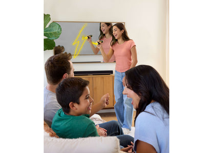 Mattel Pictionary Air Takeover Drawing Game with players using air pen while others guess on TV