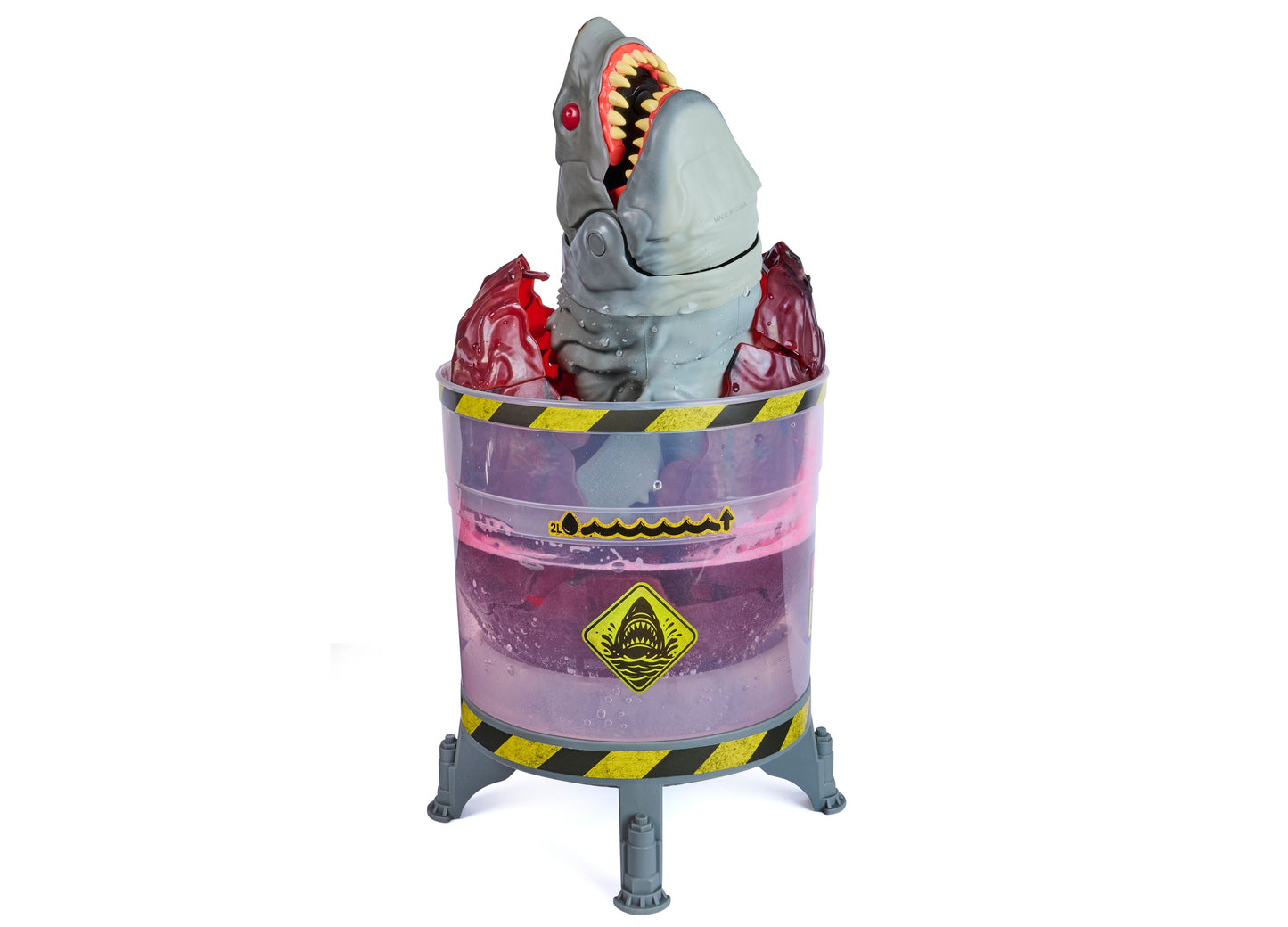 Primal Hatch Megalodon toy with glowing teeth emerging from purple containment pod with yellow warning stripes
