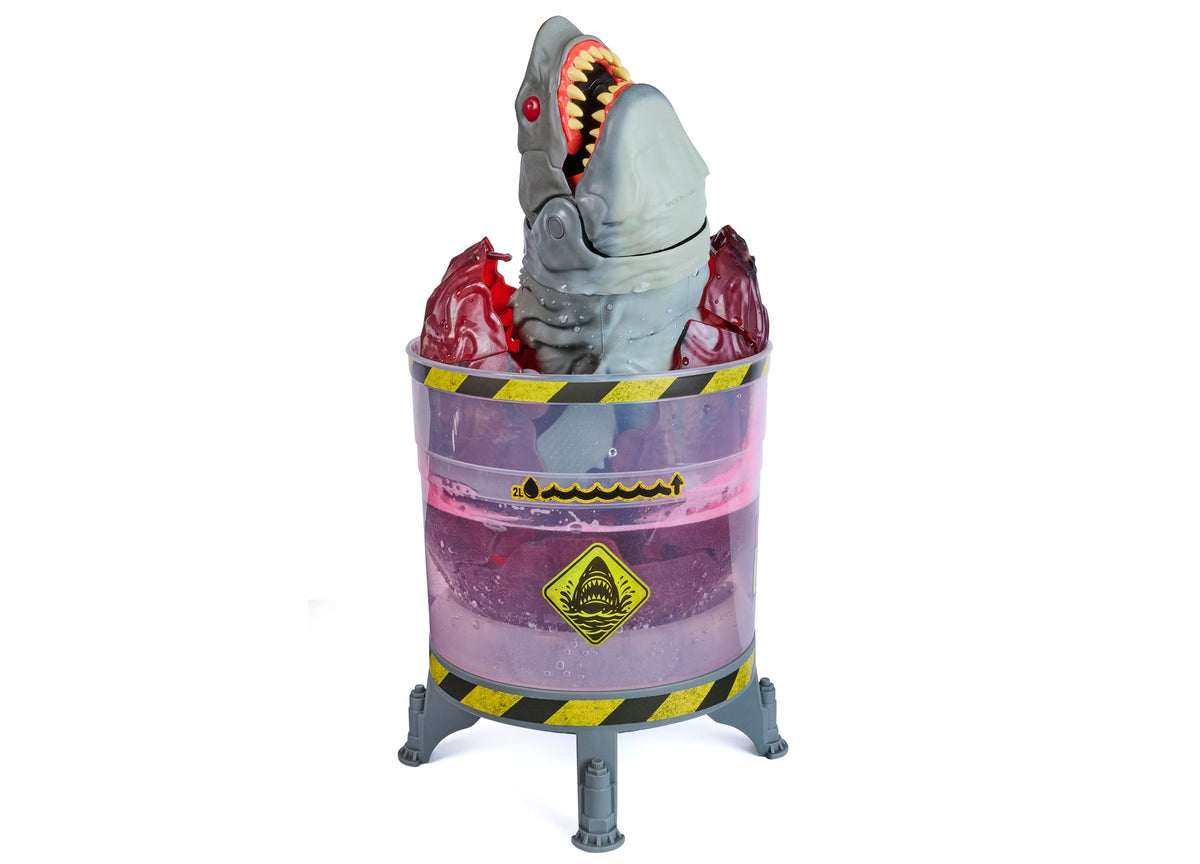 Primal Hatch Megalodon toy with glowing teeth emerging from purple containment pod with yellow warning stripes