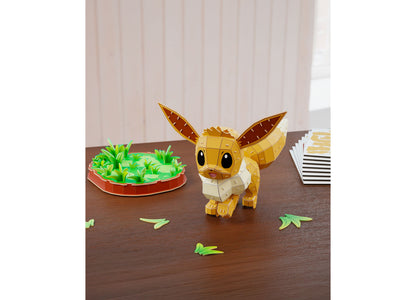 Pokemon Eevee 3D puzzle figure in tan and brown, displayed on grassy green stand with scattered green pieces