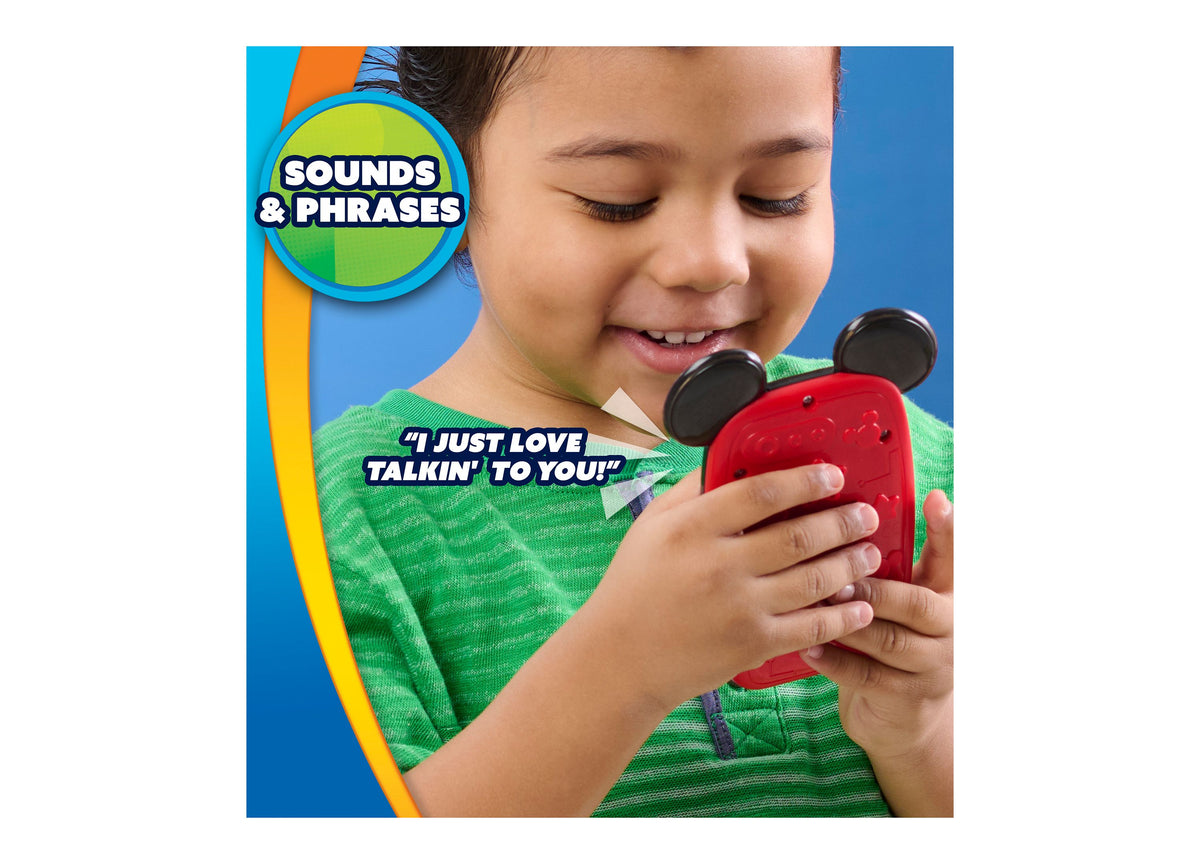 Child in green shirt holding red Mickey Mouse Clubhouse light-up interactive phone with black ears