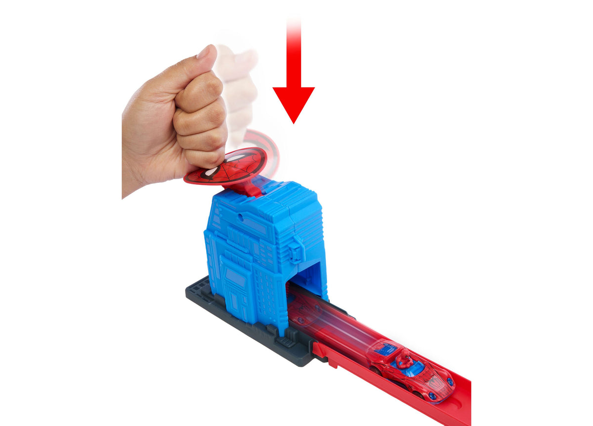 Hand pushing red Spider-Man vehicle toward blue Hulk figure on red track set with loop launcher