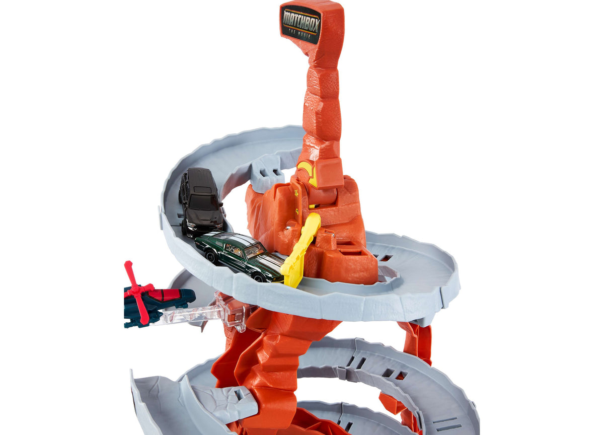 Matchbox The Movie Helicopter Escape Playset with red and gray tracks, orange helicopter launcher, and die-cast car