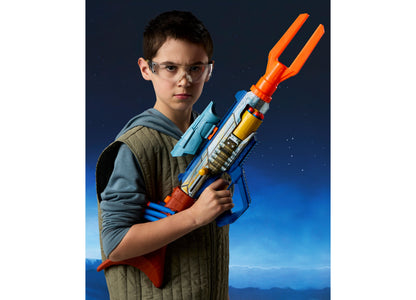Boy wearing safety glasses holds blue, orange and yellow Nerf Star Wars Mandalorian Bolt-Action Blaster against blue ...