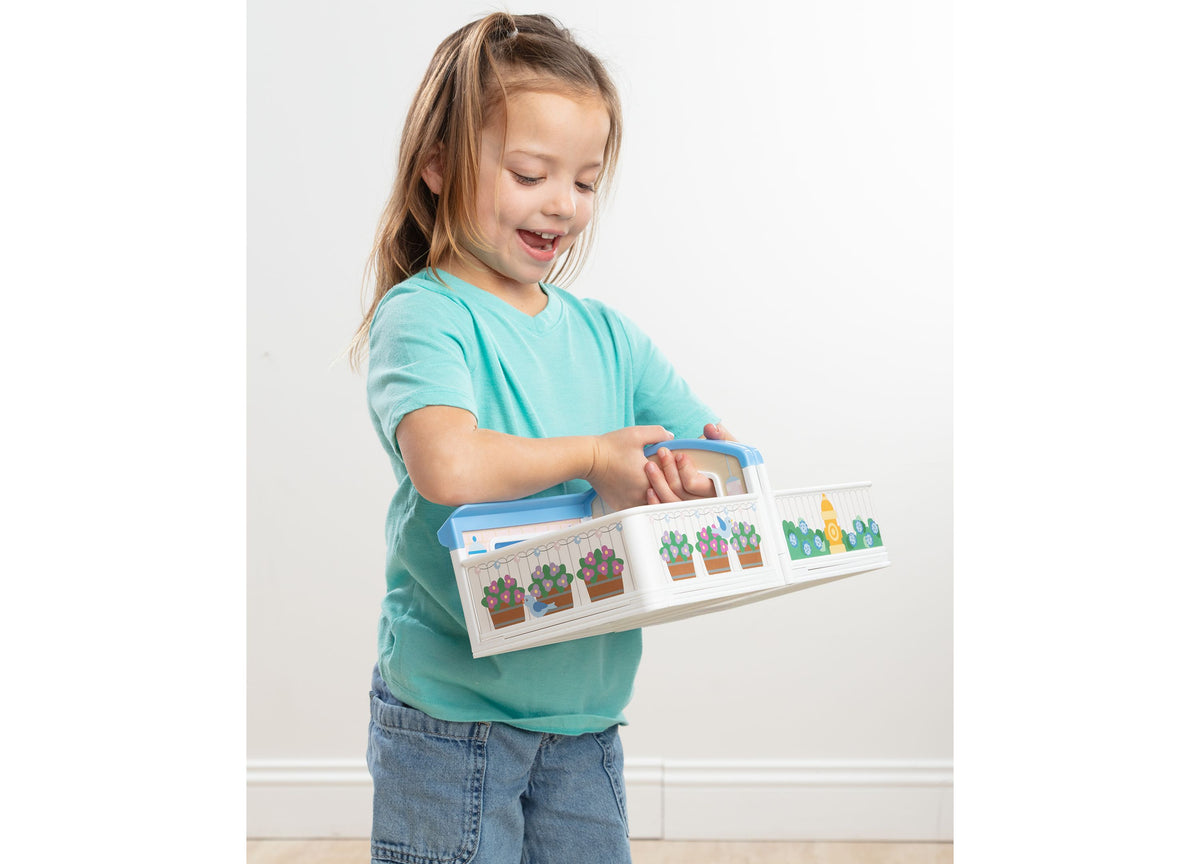Melissa & Doug Cheery Lane Fold-Out Rooms House with girl opening doors on cactus-themed rooms