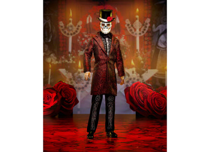 Barbie Día De Muertos Ken doll in crimson jacket with skeleton embroidery, mask, and top hat against red roses and or...