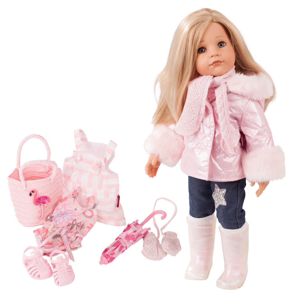 Gotz Hannah posable doll with blonde hair wearing pink jacket with fur trim, dark pants, and white socks, displayed with pink accessories including basket, umbr