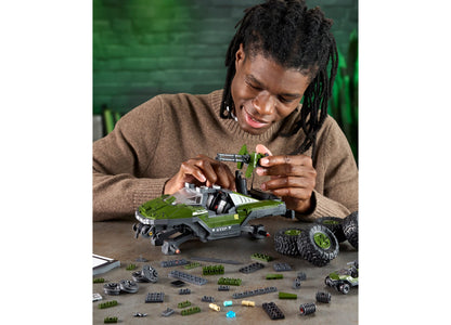 Hands assembling green and gray UNSC M12 Warthog building set with cannon detail and separate die-cast vehicle
