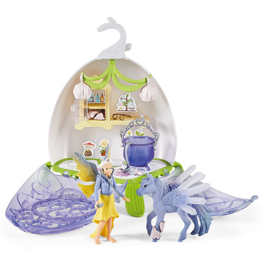 Bayala Magical Vet Blossom playset with fairy figure, winged dragon, cauldron, and shell-shaped house with green canopy and hanging white elements