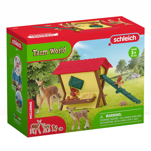 Schleich Farm World Feeding The Forest Animals Playset box showing a yellow wooden shelter with red roof, deer figures, hedgehog, and green feeding trough on gr