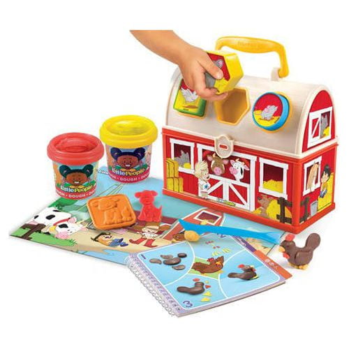 Little People Fun Dough Farm playset with red barn carrying case, modeled by a child's hand placing dough, includes two dough containers, activity guide, and co