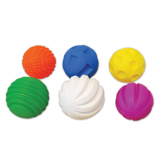 Six colorful tactile sensory balls in orange, green, blue, white, yellow, and magenta with textured surfaces on plain background