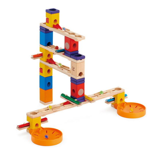 Hape Quadrilla Music Motion wooden marble run with colorful stacked blocks, wooden ramps, orange spin plates, and rolling marbles on plain white background