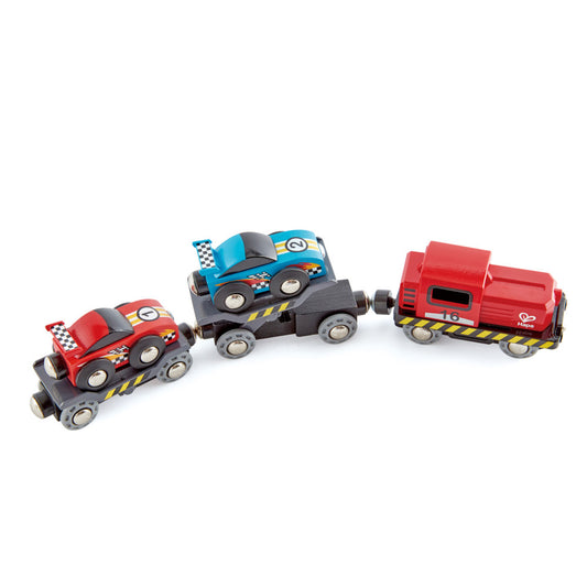 Wooden race car transporter set with three colorful vehicles—red race car, blue race car, and red delivery truck with black and yellow stripe details, all conne