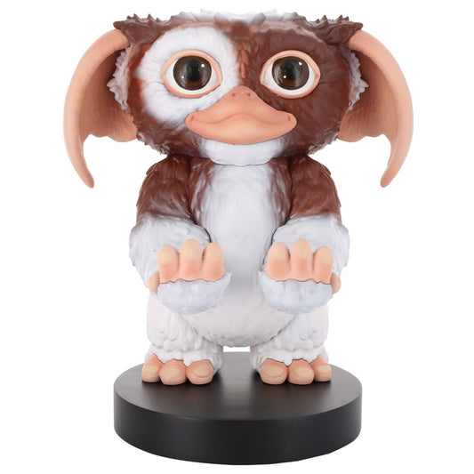 Brown and white Gizmo figure with large ears, big eyes, and peach-colored features, seated on a black base