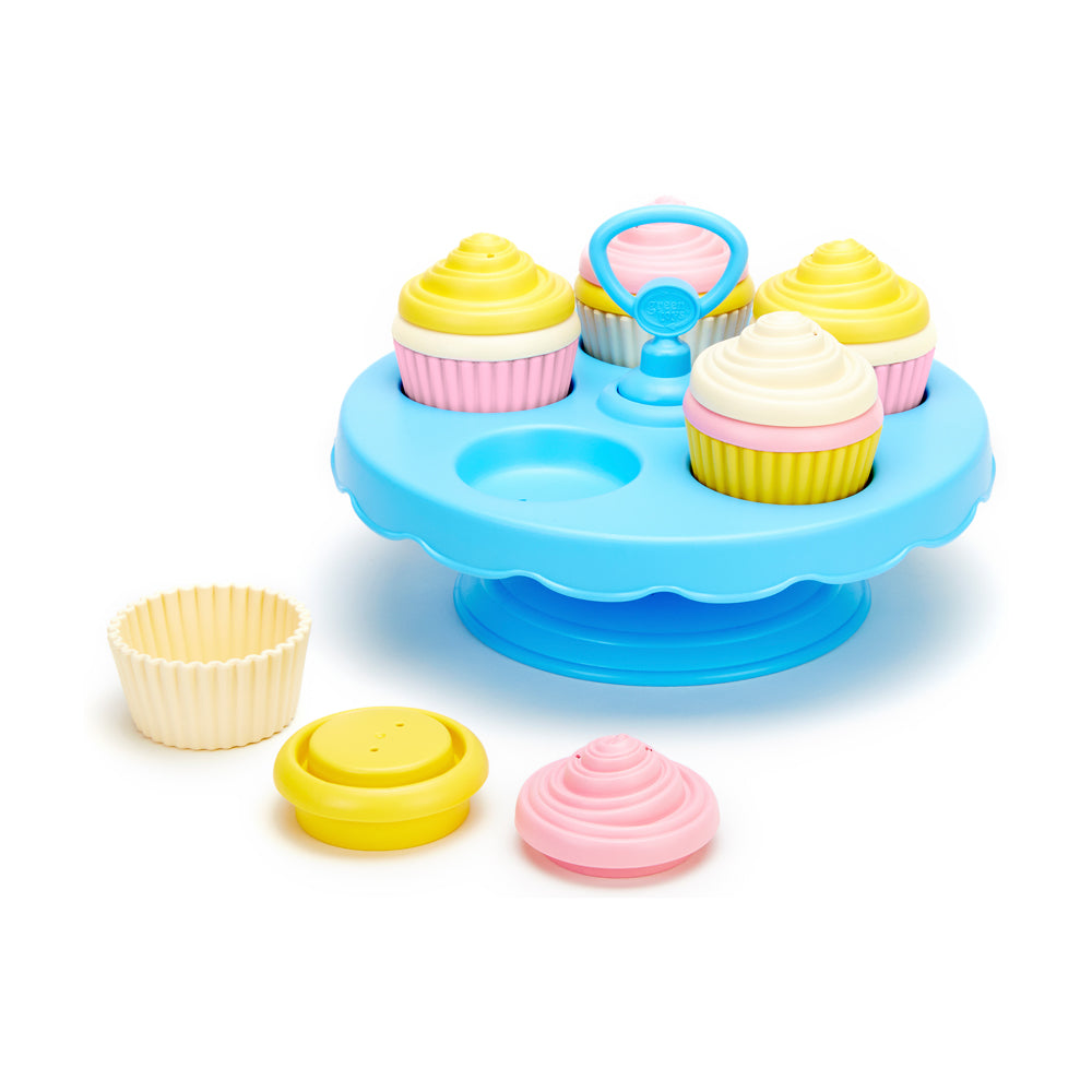 Blue cupcake stand playset with four colorful pretend cupcakes featuring yellow and pink frosting, a blue tweezer tool, empty cupcake liner, and loose frosting