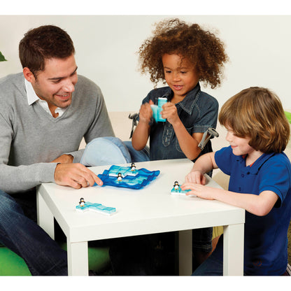 SmartGames Penguins on Ice sliding puzzle game with blue board played by adult and two children