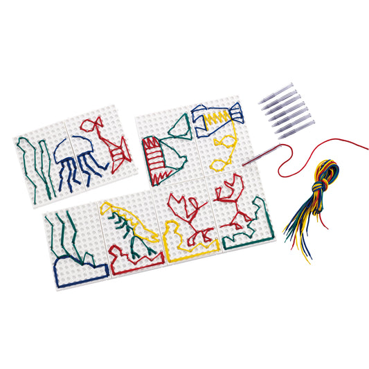 String art creative set with six pegboards featuring colorful yarn designs of sea creatures, colorful string, and marker pens