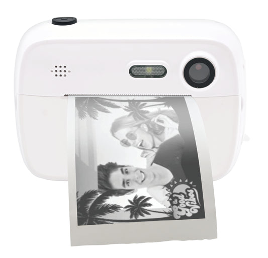 White digital camera with black lens and speaker grille, printing out a black and white photo of two children