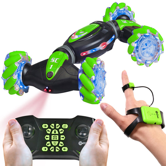 Green and black remote control crawler with glowing blue wheels and LED lights, shown with wireless controller and finger ring remote, modeled by hands on plain