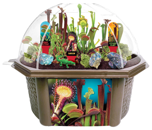 Biosphere terrarium dome kit displaying carnivorous plants including Venus flytrap, sundew, and pitcher plant with labeled red tags, moss, rocks, and educationa