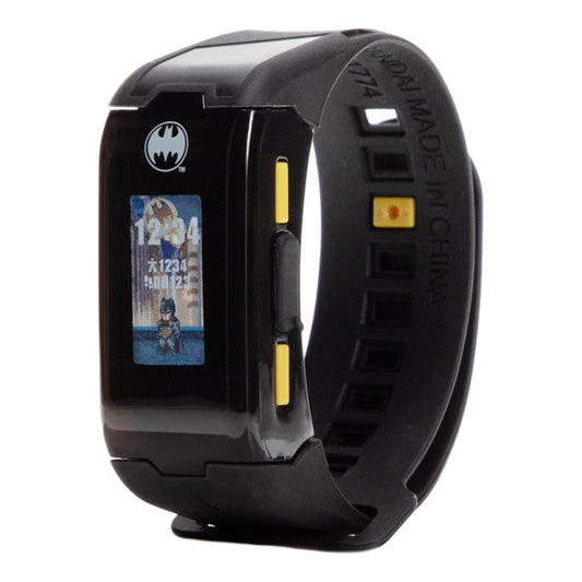 Batman interactive fitness tracker band with black wristband, yellow accent buttons, and small display screen showing Batman character artwork