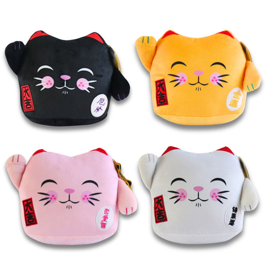Four plush Maneki Neko lucky cat cushions in black, gold, pink, and white with red ears, smiling faces, pink cheeks, raised paws, and red character tags