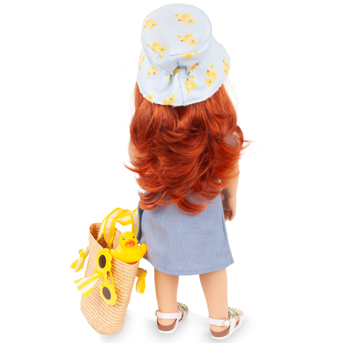 Gotz Hannah Little Duck 19.5" doll with red hair, blue dress, yellow duck accessories, and straw tote bag