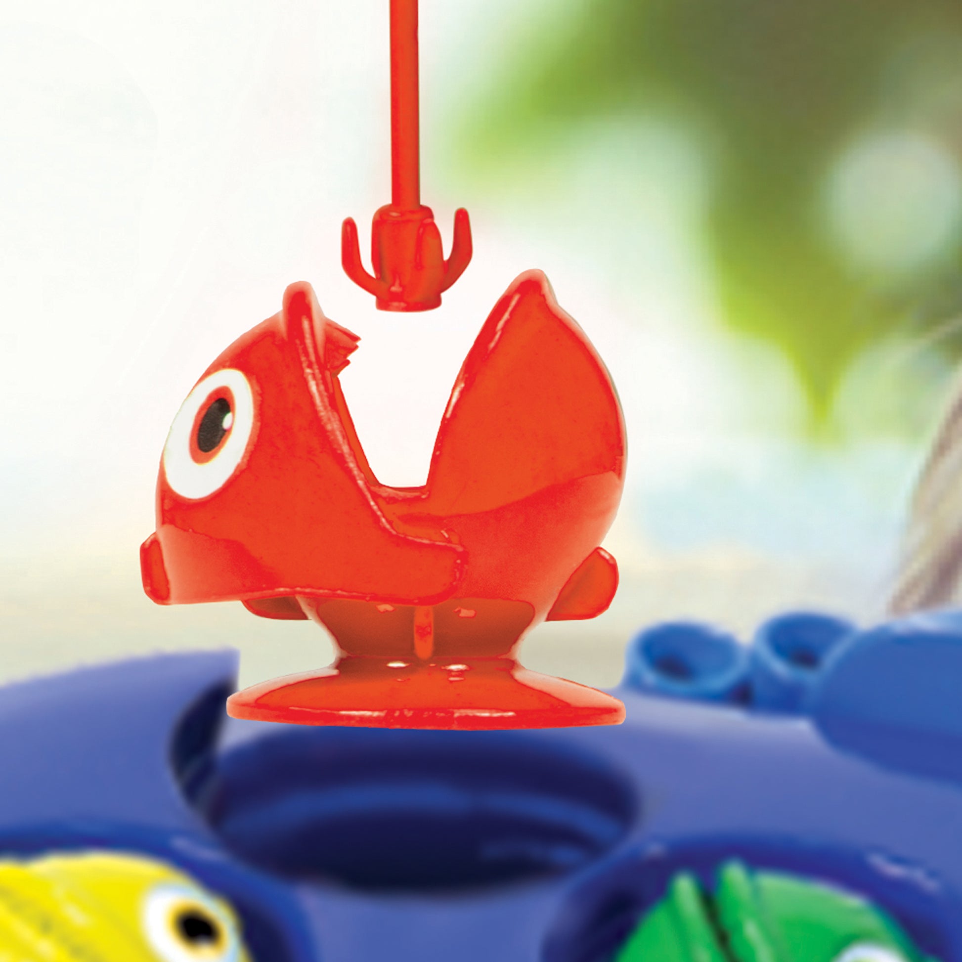 Red fish toy with white eye from Ambassador Games Fishing Game, includes rod and blue base