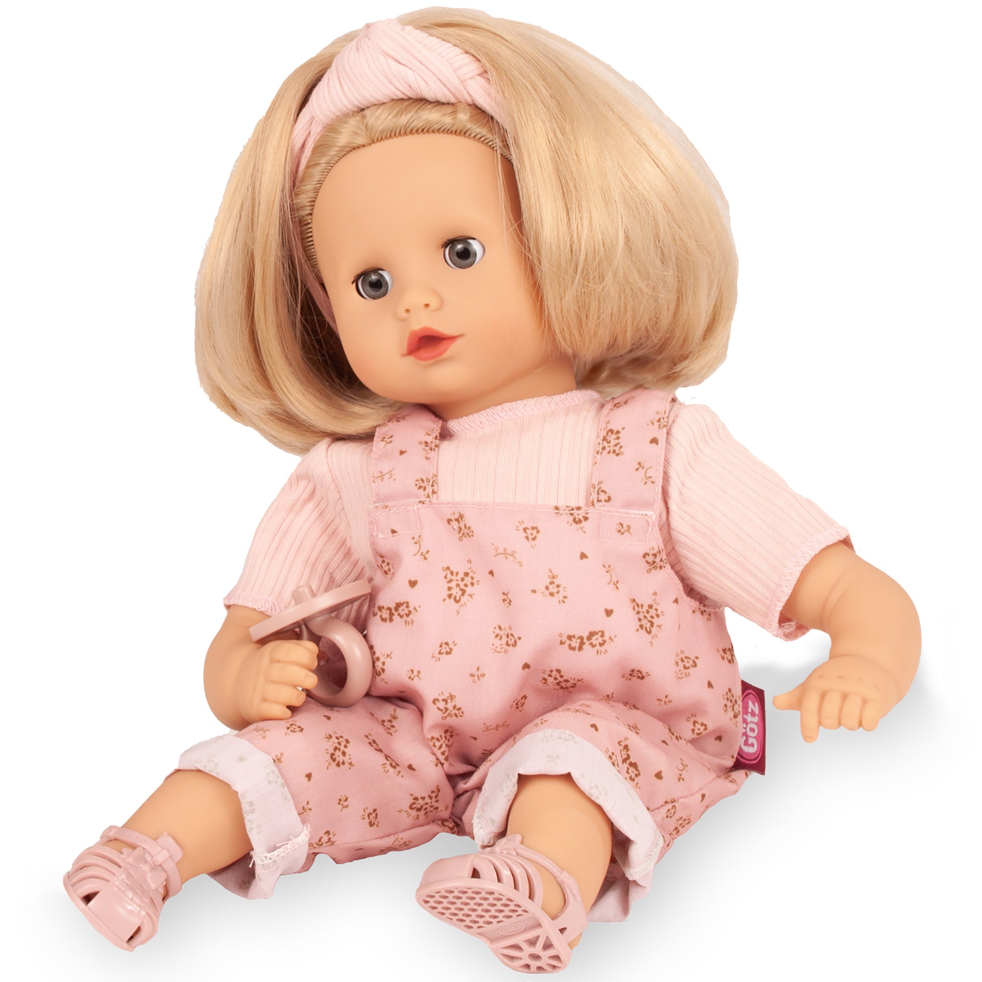 Gotz Muffin 13" doll with blonde hair, pink floral overalls, and matching headband