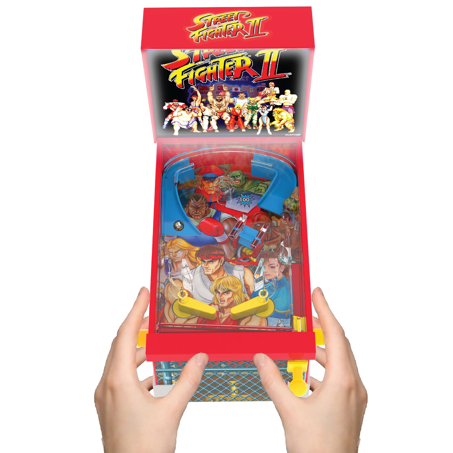 Street Fighter II Mini Arcade Pinball game with red case, blue playfield, held in hands