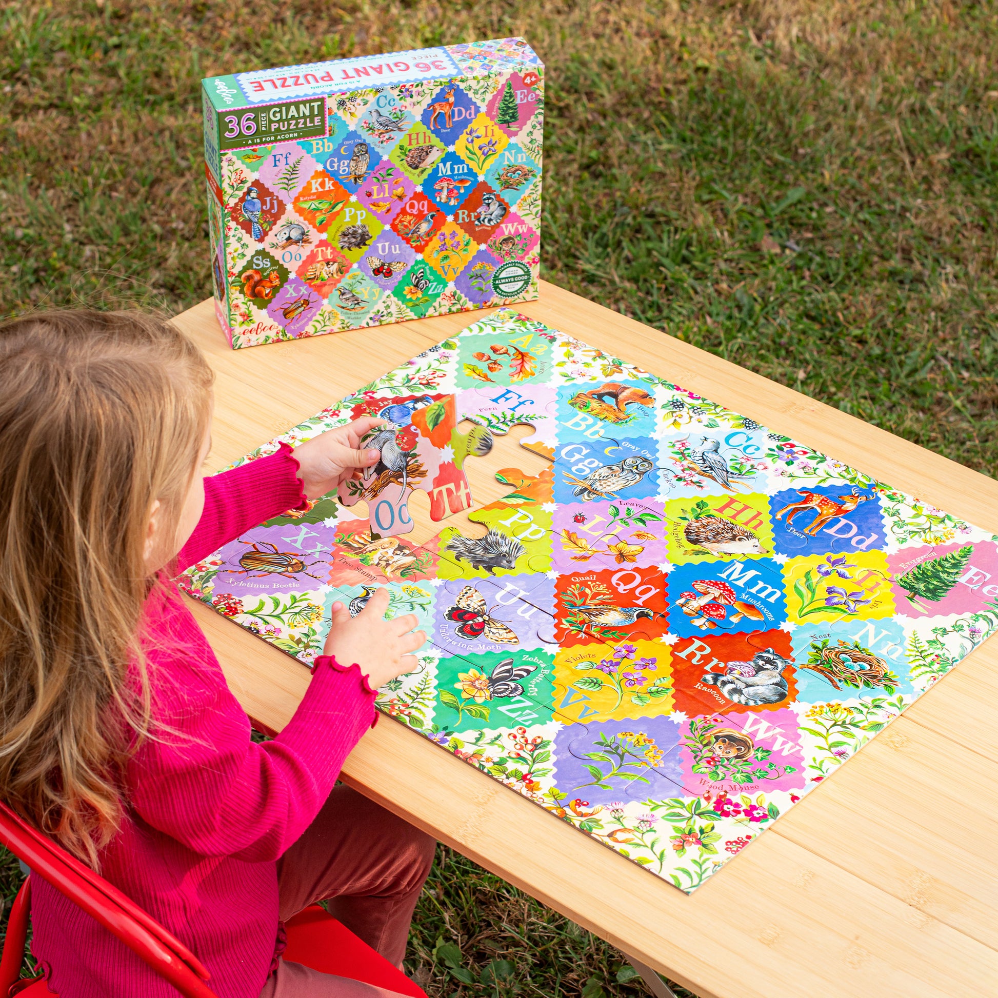 36 Piece Giant Alphabet Puzzle with colorful letters and nature illustrations, child playing outdoors