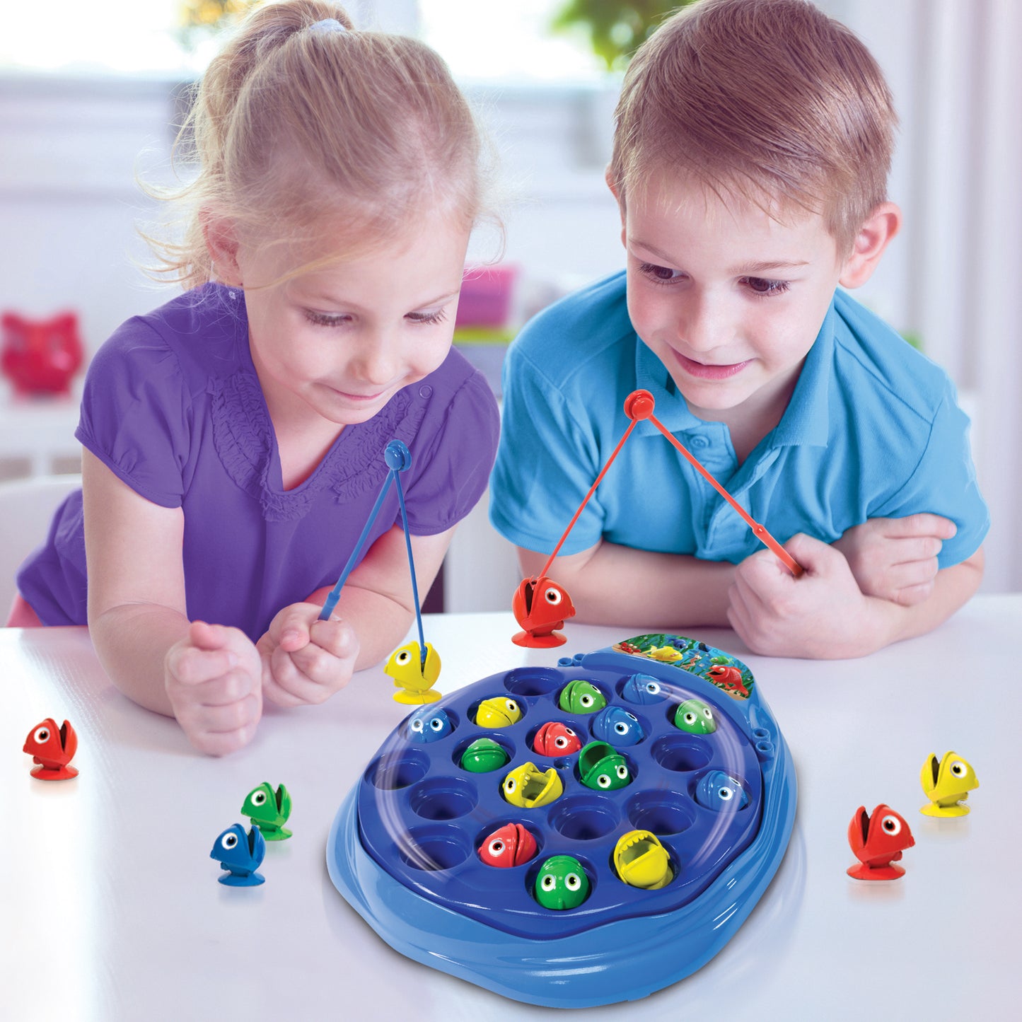 The Fishing Game by Ambassador Games - two children playing with colorful spinning fish and magnetic rods