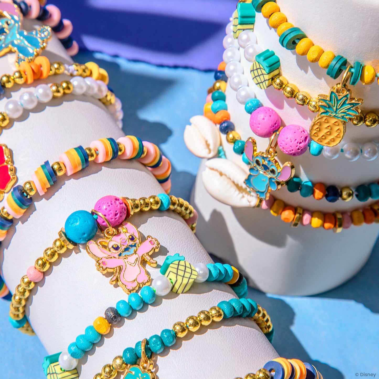 Disney Stitch DIY Jewelry Kit with colorful beaded charm bracelets featuring pineapple and shell charms in turquoise,...