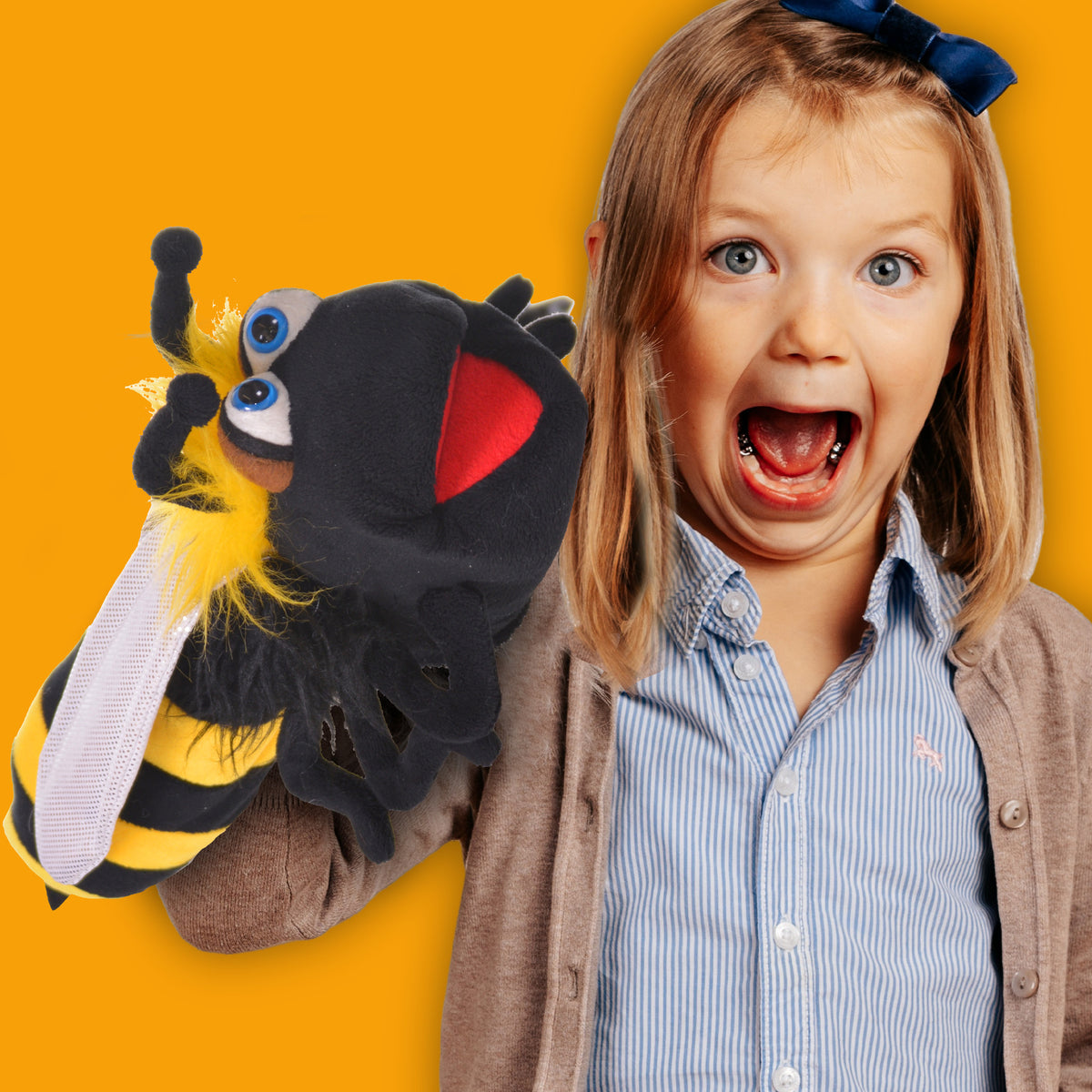 Living Puppets: Biz The Bumble Bee hand puppet with yellow and black stripes, shown with child