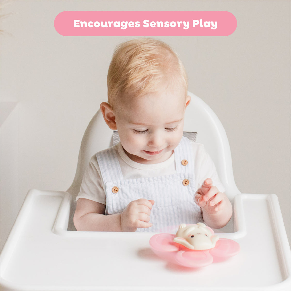 Sensory Spinner: Bunny toy with pink spinner paddles and bunny character, baby playing with toy at highchair