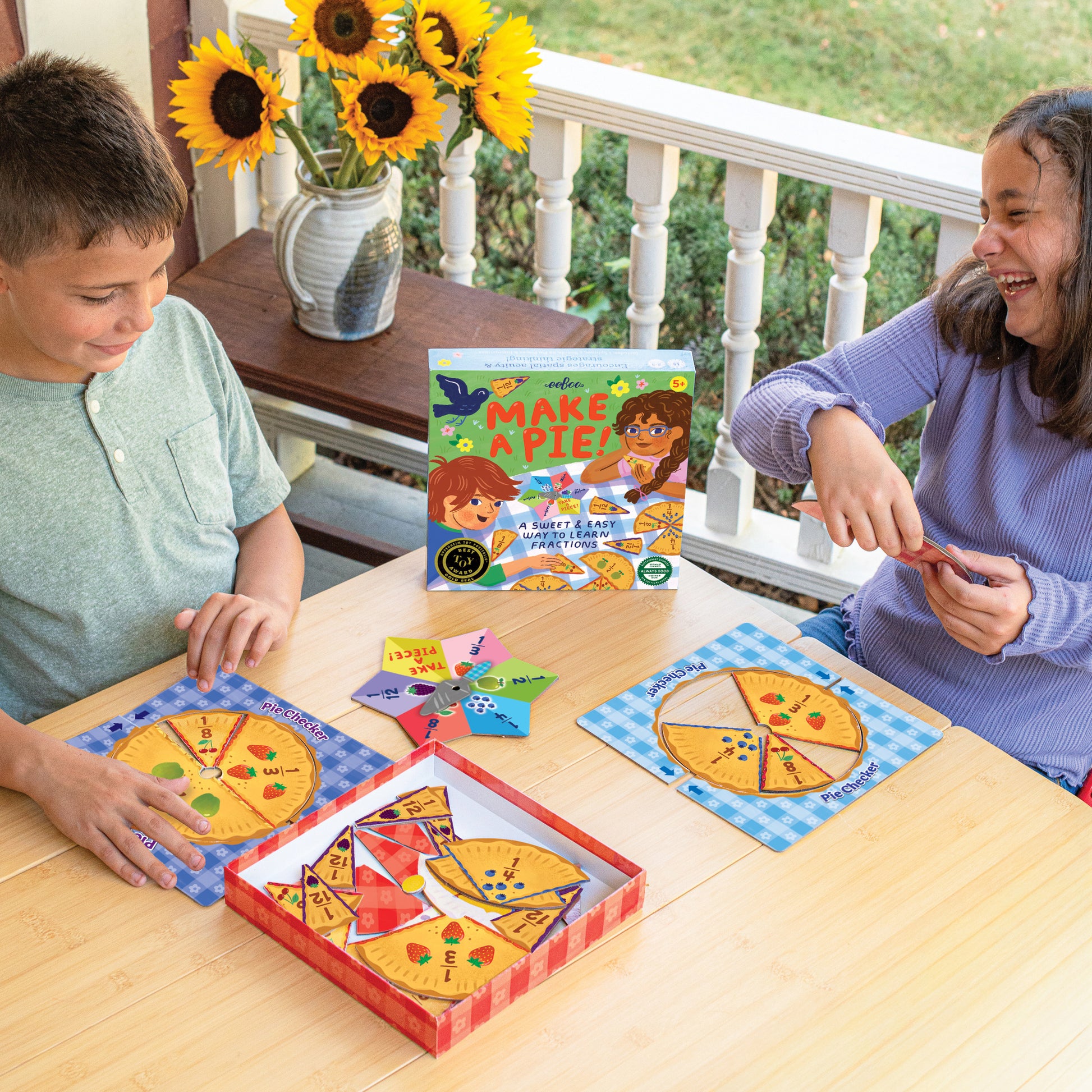 Make A Pie Game educational toy with pizza fraction pieces, colorful game board, and learning cards on wooden table