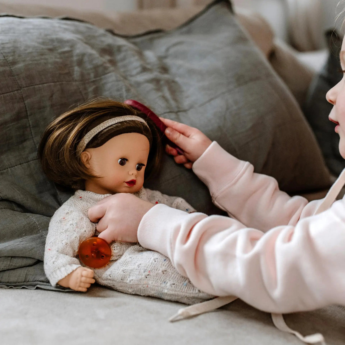 Muffin Doll 13" soft doll with brown hair, beige knit jumpsuit, headband, and pacifier