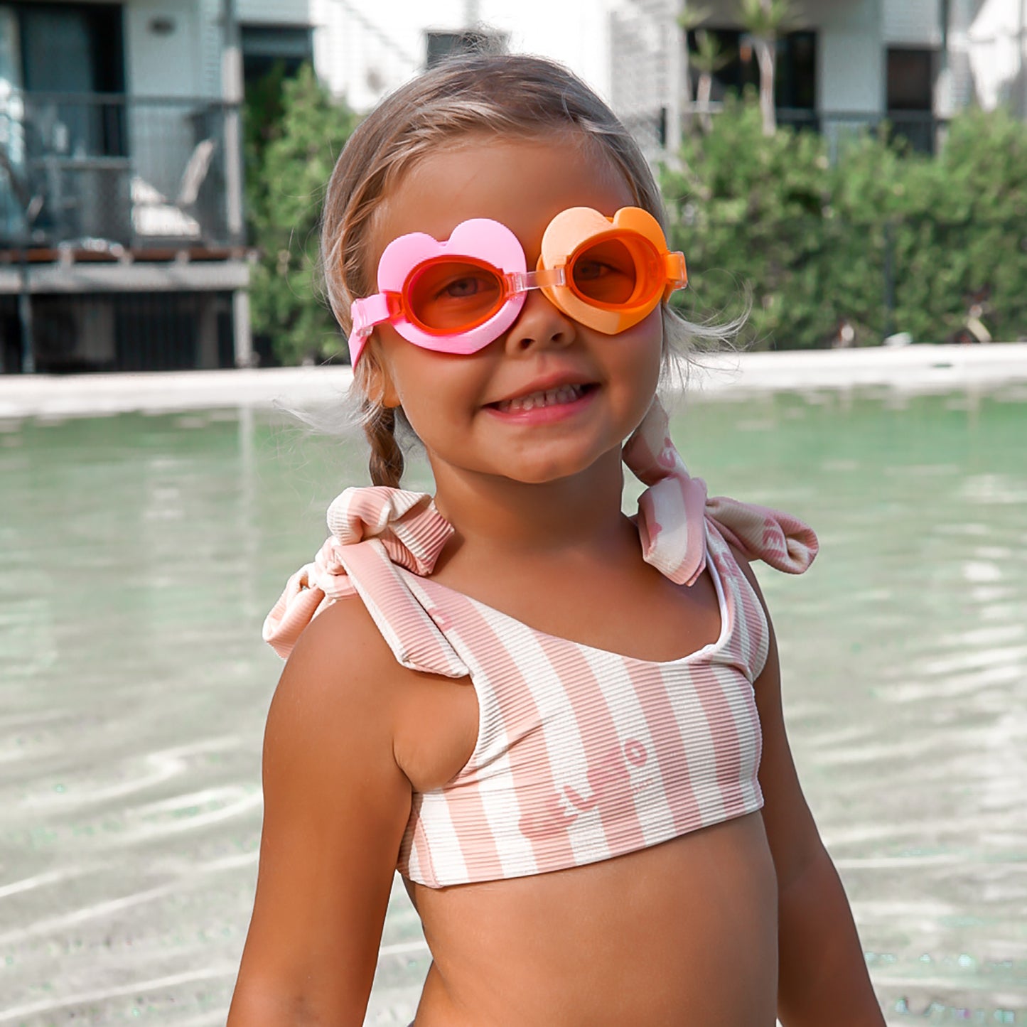 Poppy the Peach swimming goggles in pink and orange worn by child