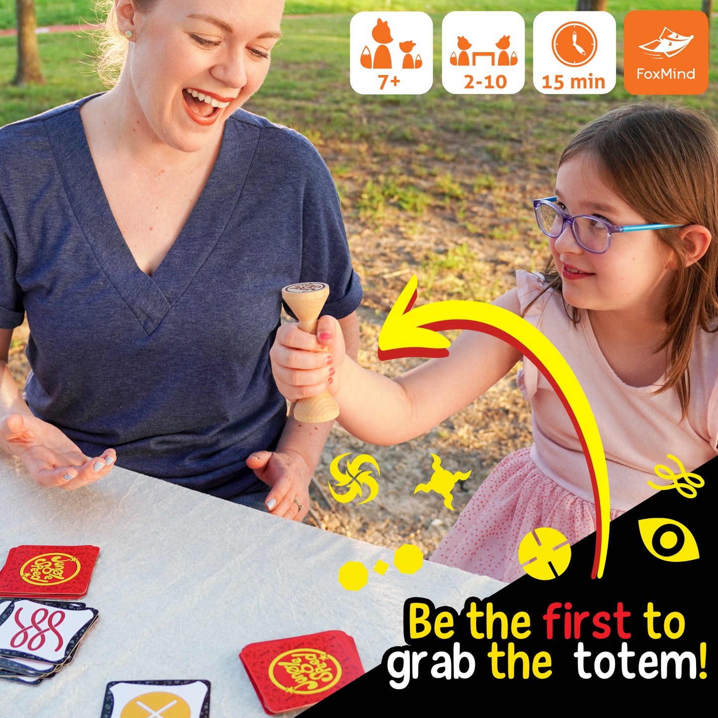 Jungle Speed Eco Edition card game with wooden totem, players matching cards and grabbing totem first