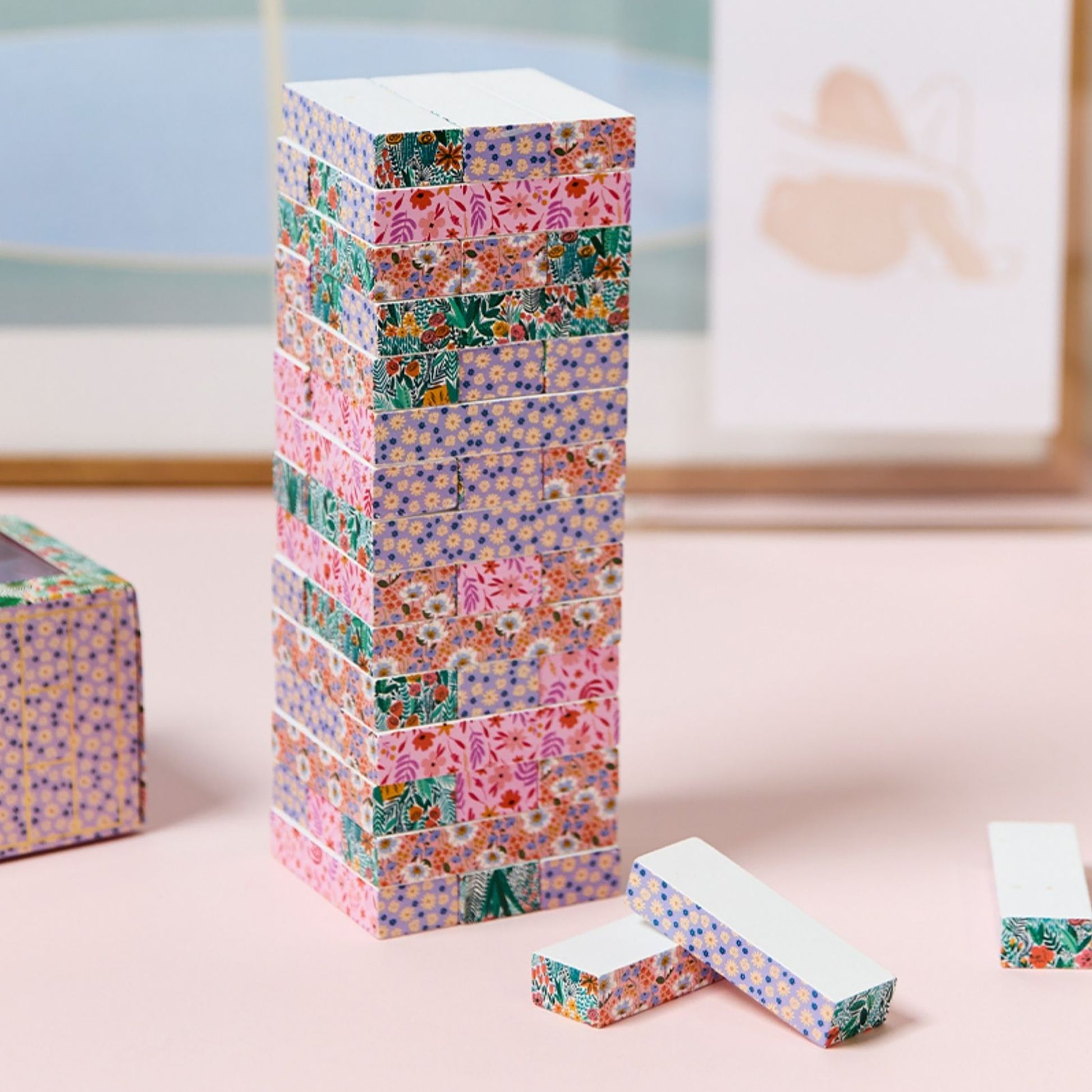 JOS Tumbling Tower wooden block game with colorful floral patterns