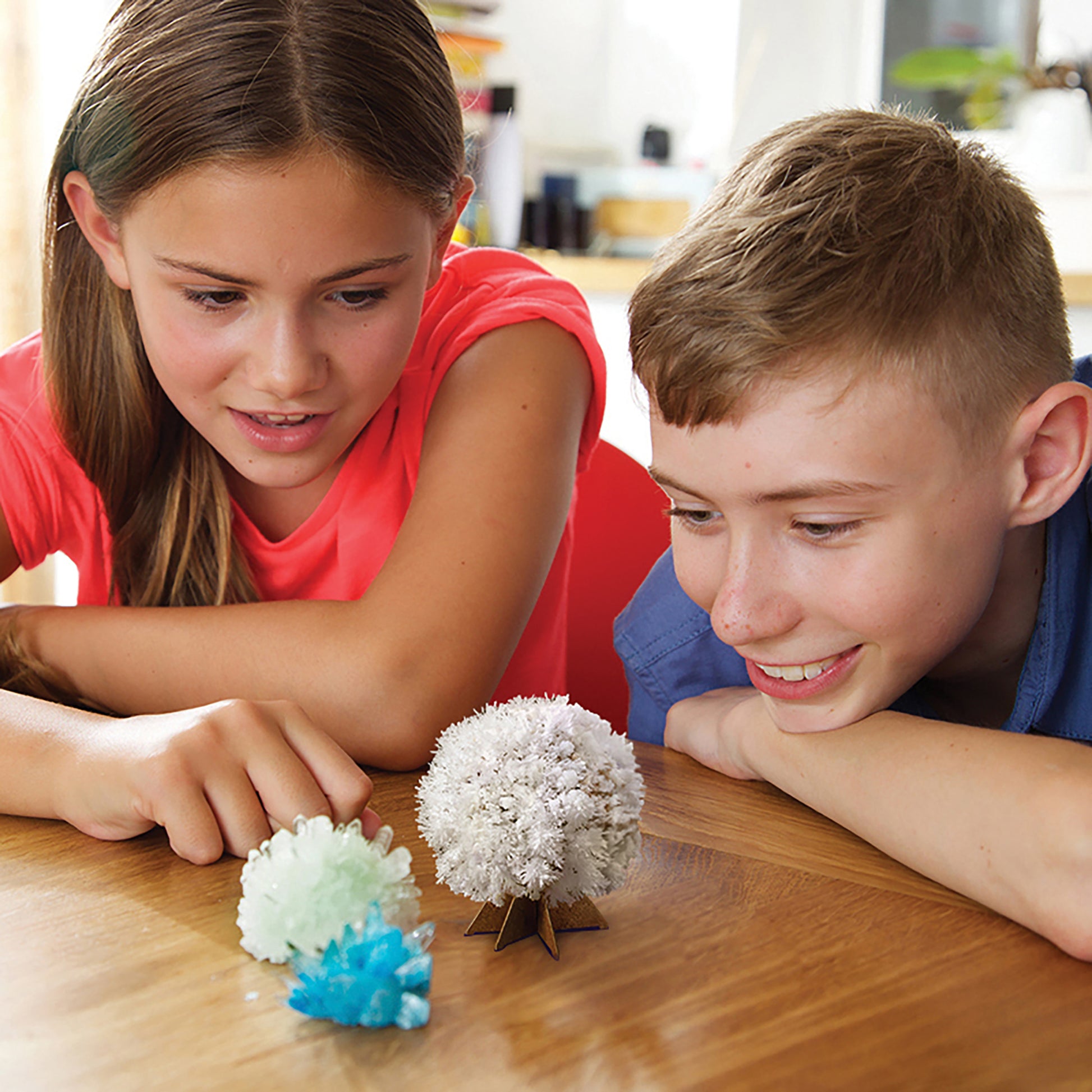 4M KidzLabs Crystal Science Kit with three colorful grown crystals in white, green, and blue