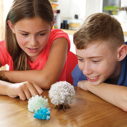 4M KidzLabs Crystal Science Kit with three colorful grown crystals in white, green, and blue