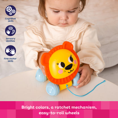 Kids Hits Push & Pull Lion toy in yellow and orange with blue wheels, featuring rotating head and ratchet mechanism