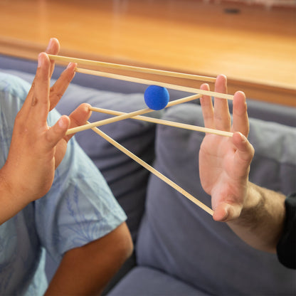 KESS Yubibo cooperative game with two players holding wooden sticks and blue ball, skill and balance toy