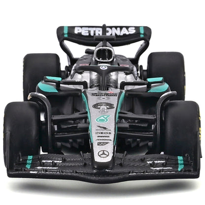 Bburago 1:43 Mercedes W16 Formula race car in black, white and turquoise with pit pass playset