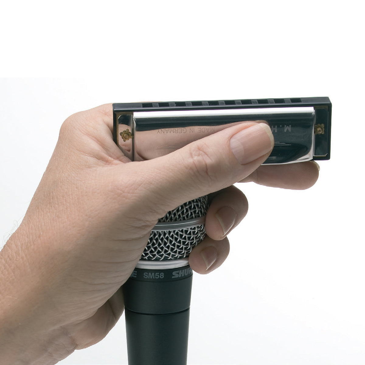 Hinkler Retro Box Harmonica in black held in hand against white background