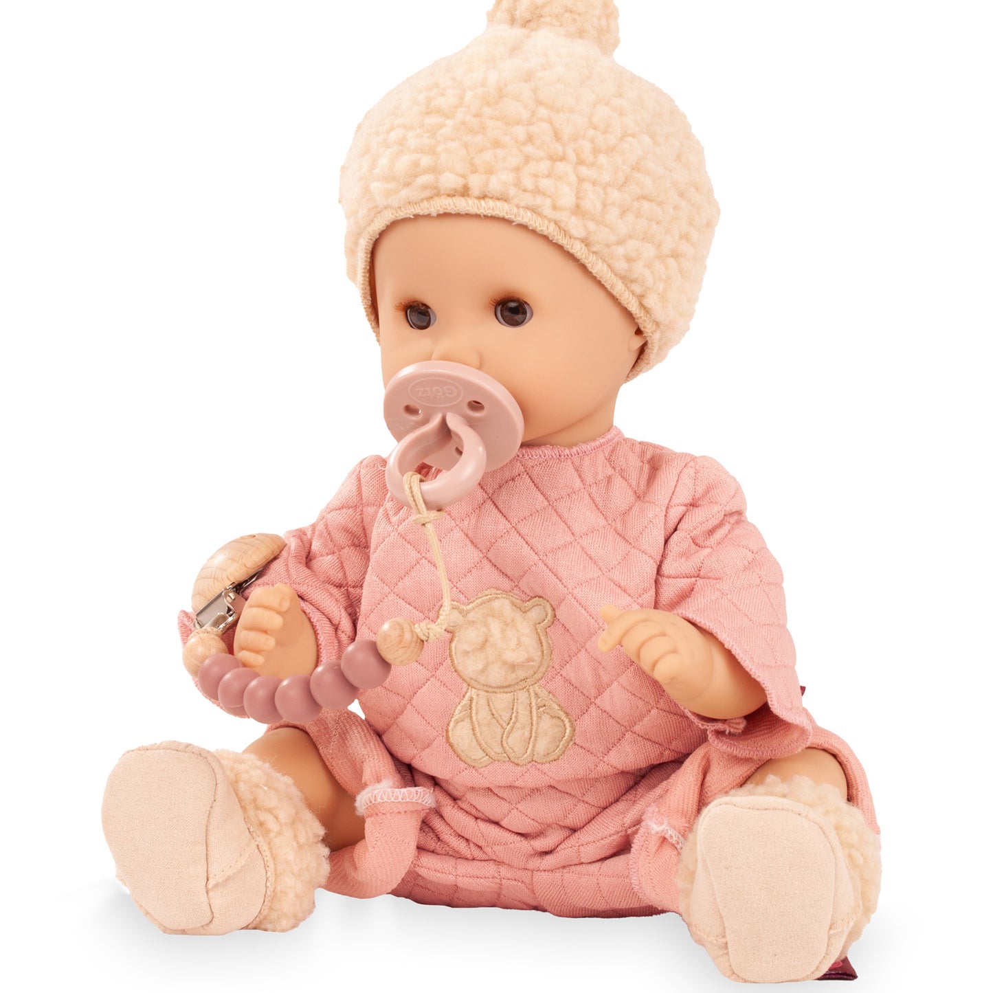 Gotz Sleepy Aquini Baby Doll in pink outfit with beige hat, holding bottle and pacifier