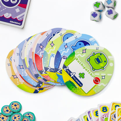 Tamagotchi Collections board game with colorful cards, dice, and tokens for ages 8+