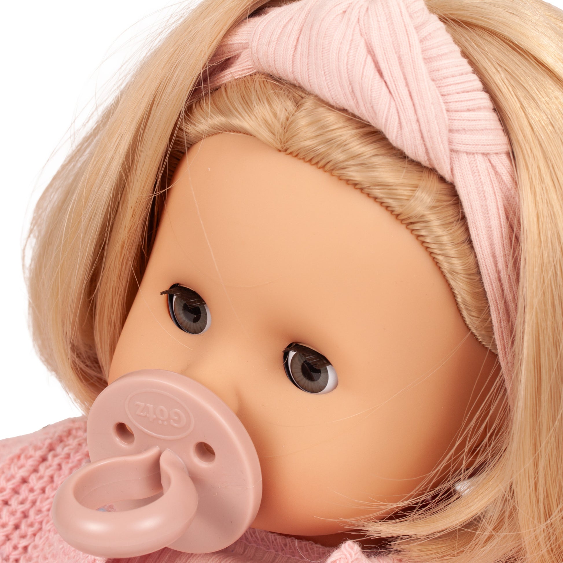 Gotz Muffin Flowers doll with blonde hair, pink headwrap, and pacifier